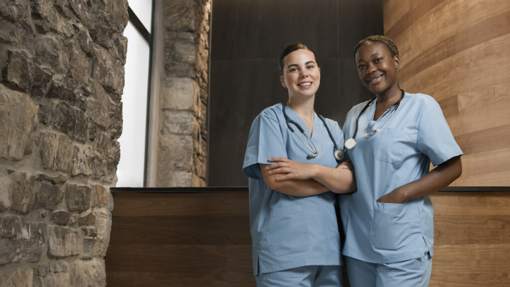 two female nurses working clinic scrubs